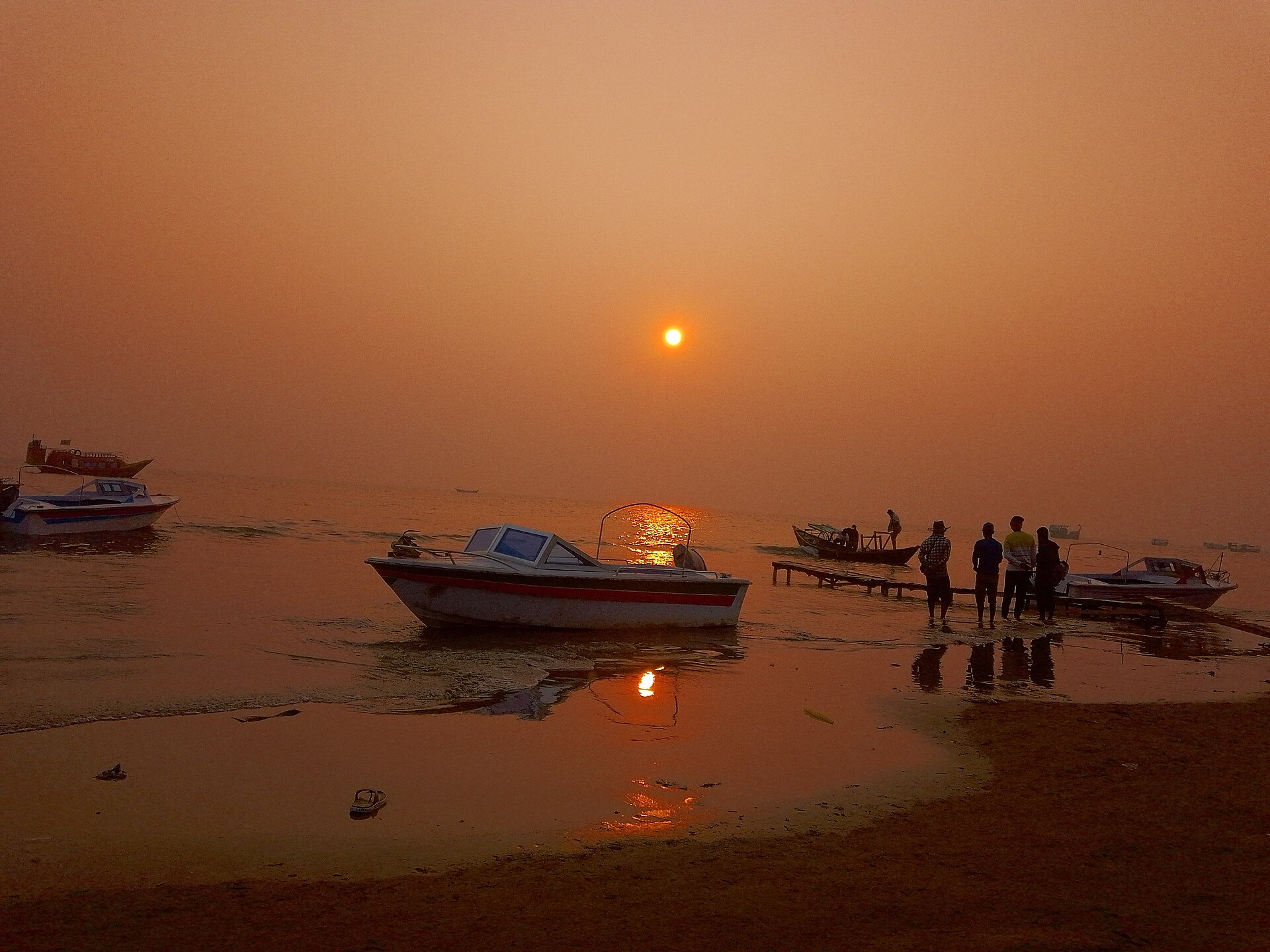 Boats and people on the shore at sunset, Kuakata